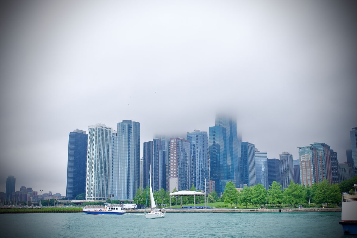Chicago's skyline disappears into low fog above the lakefront.