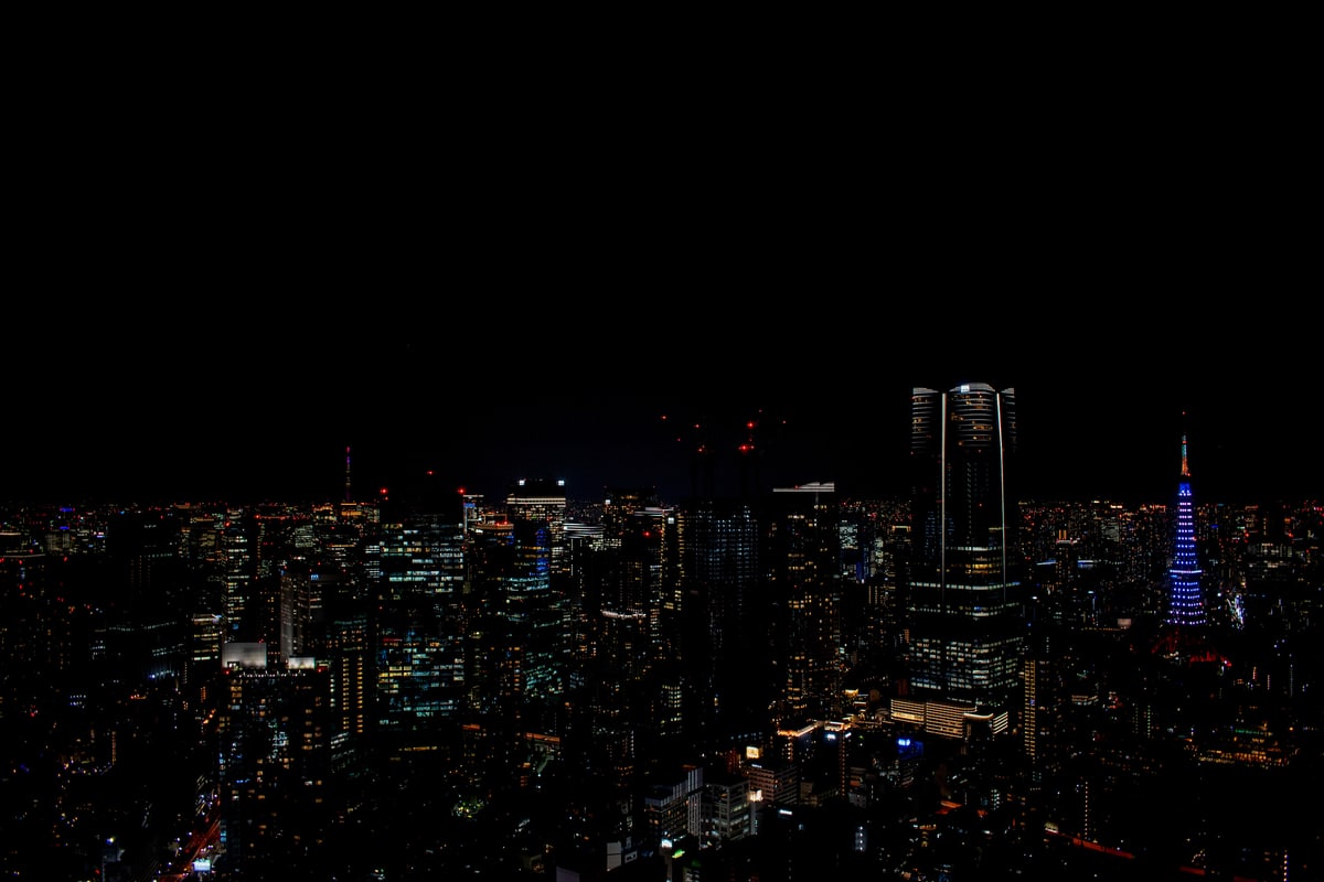 Tokyo's skyline at night with Tokyo Tower glowing among the high-rises.