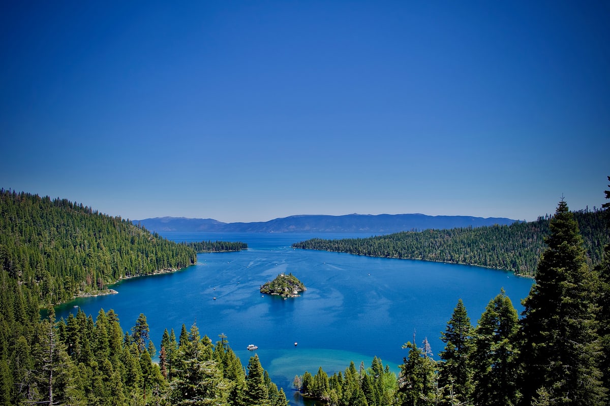 Emerald Bay on Lake Tahoe framed by pine trees, a small island in the middle.