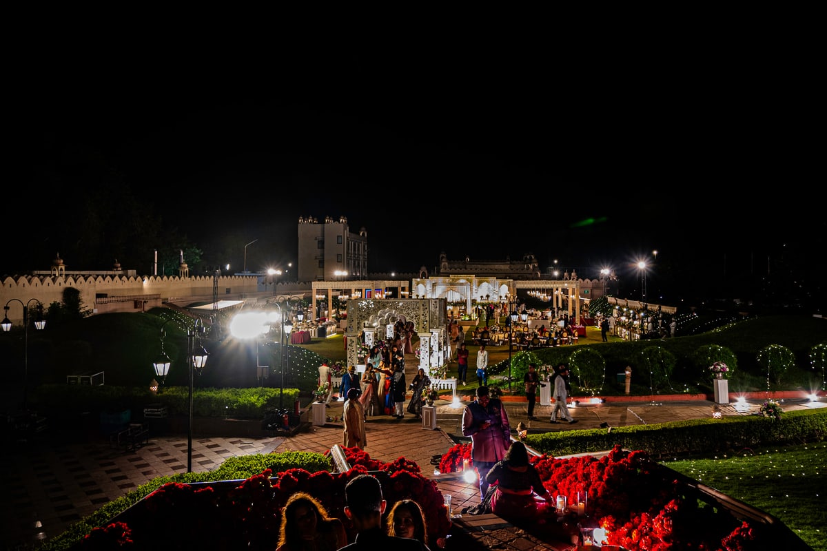 The palace grounds glow with warm lights under a dark night sky.