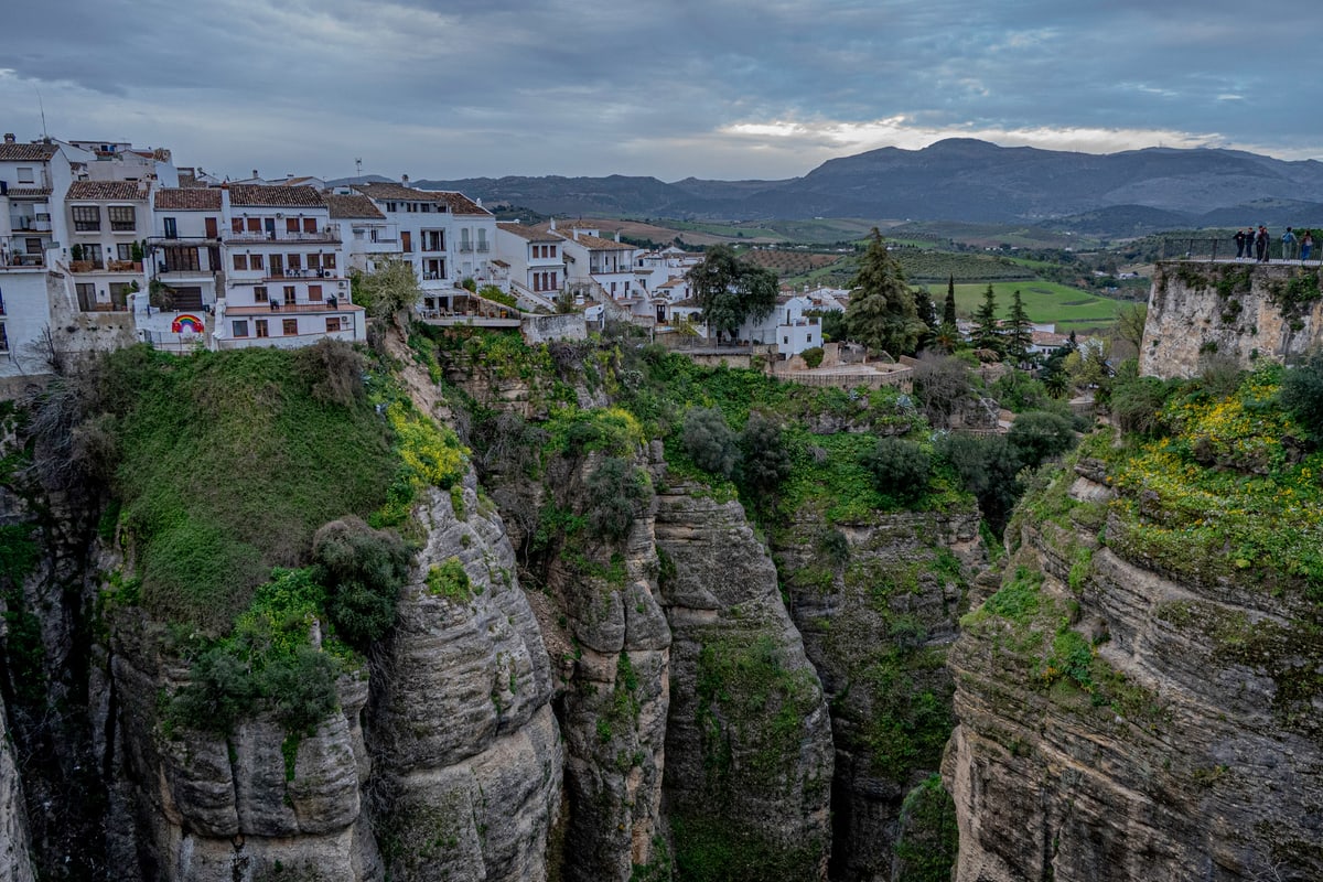 White houses of Ronda perched on the edge of a deep limestone gorge.